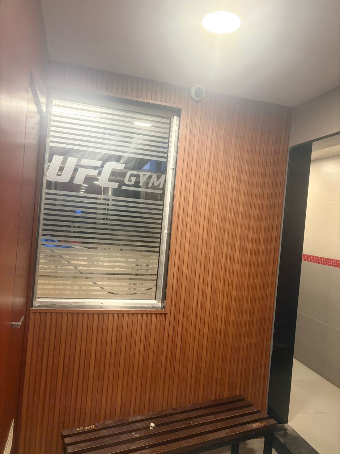 Wudonn D-2 fluted WPC panel installation in the UFC Gym corridor, Mumbai