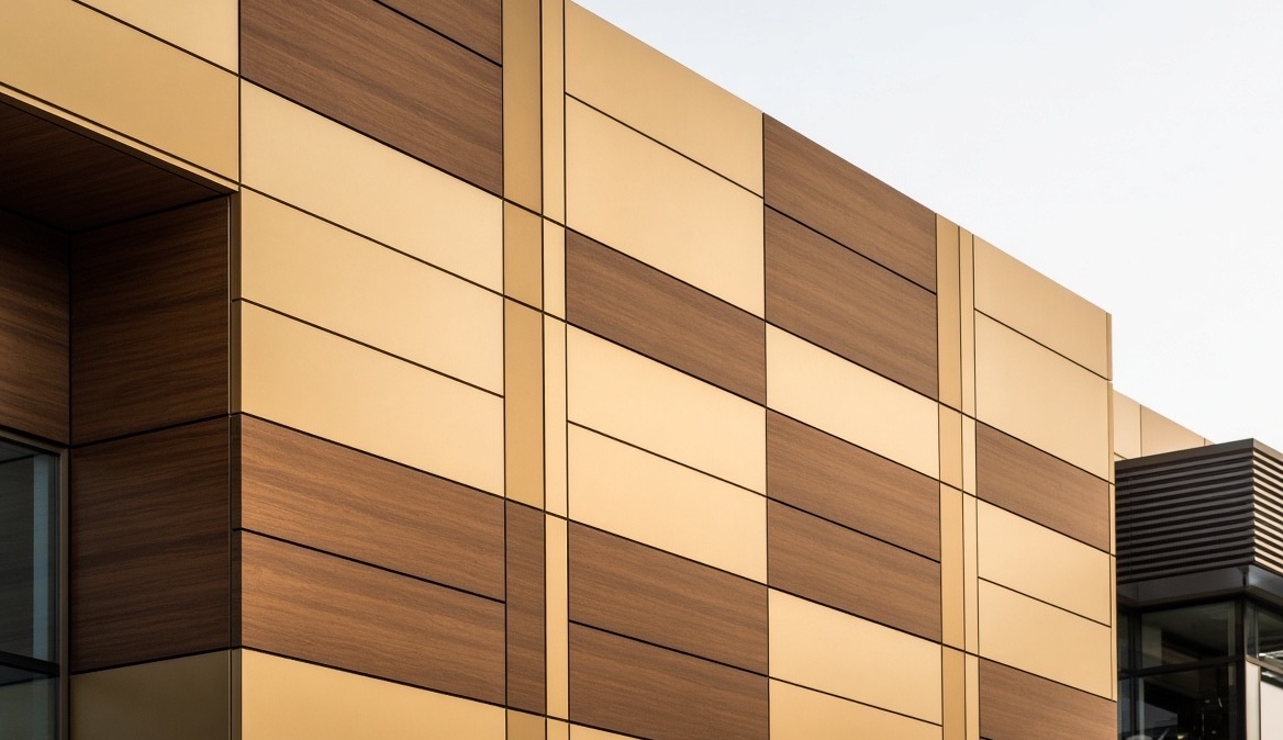 Wood and gold aluminium composite cladding on a building exterior