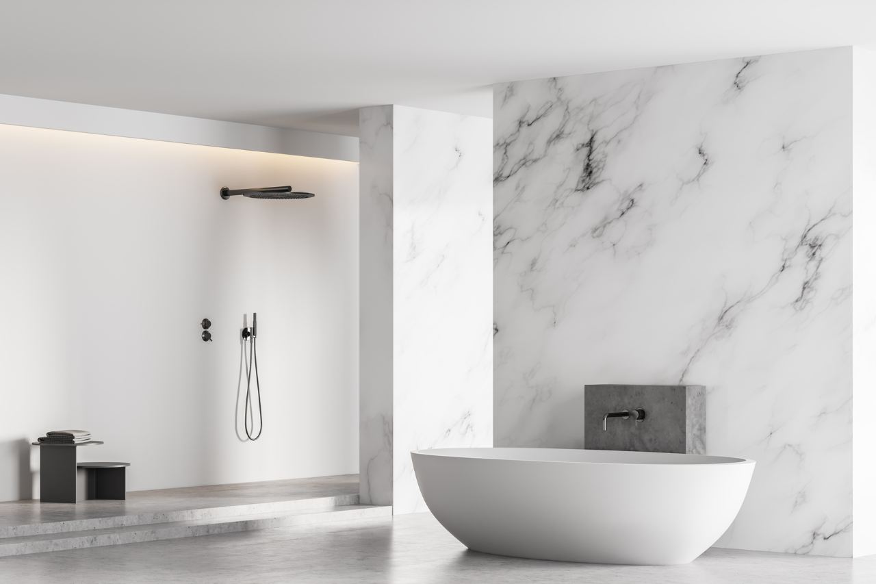 Bathroom with a marble-finish wall behind a freestanding bathtub