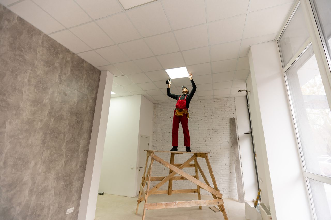 Ceiling panels being fixed onto a batten grid