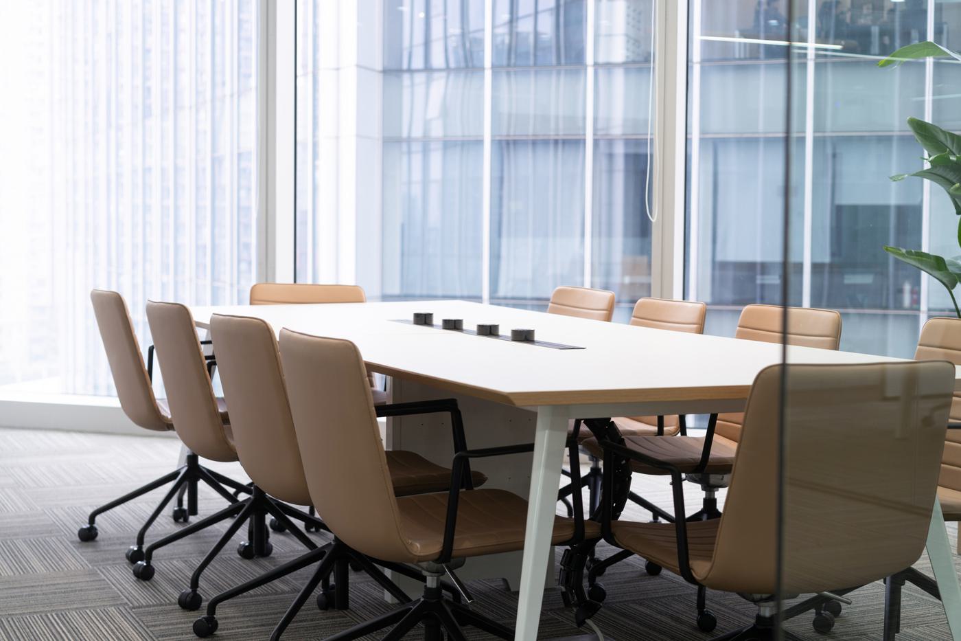 Office meeting room with a long table and glazed walls