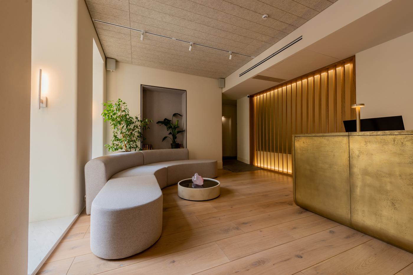 Hotel reception with a fluted desk front and a slatted feature wall
