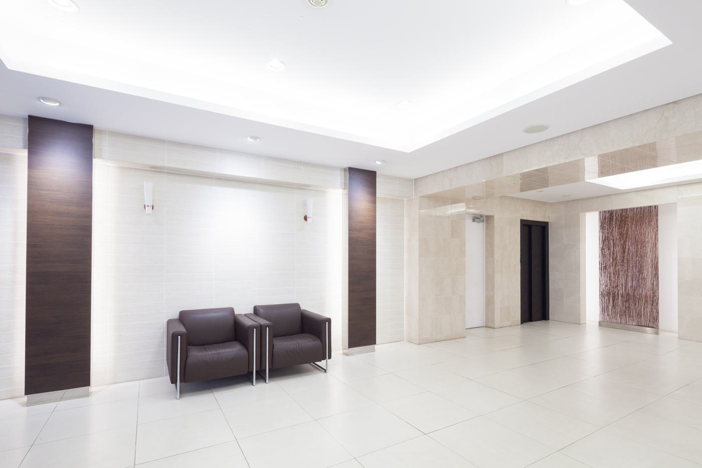 Apartment building entrance lobby with seating and panelled walls