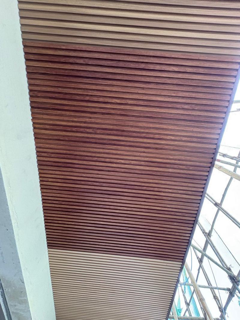 Wood-finish louvers running across a sloped mall ceiling soffit