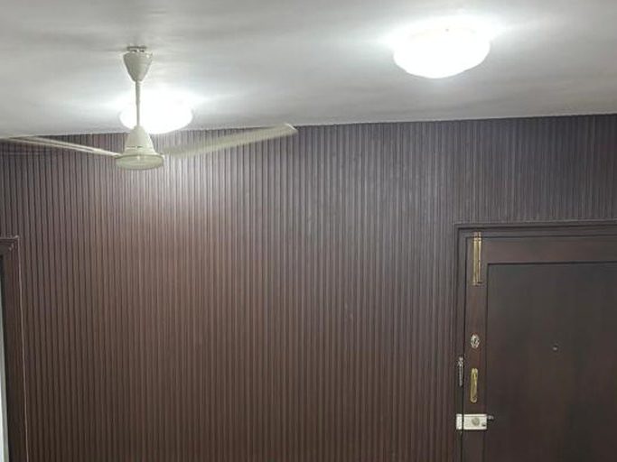 Dark charcoal wall panels across an apartment wall