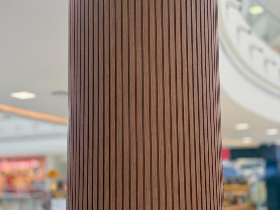 Flexible wood-finish louvers wrapped around a round column