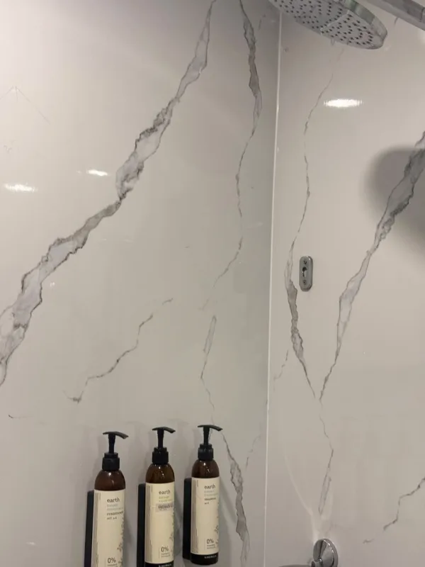 Close-up of Maestà UV marble veining in a five-star hotel washroom in Pune, a real Urbane Decor installation